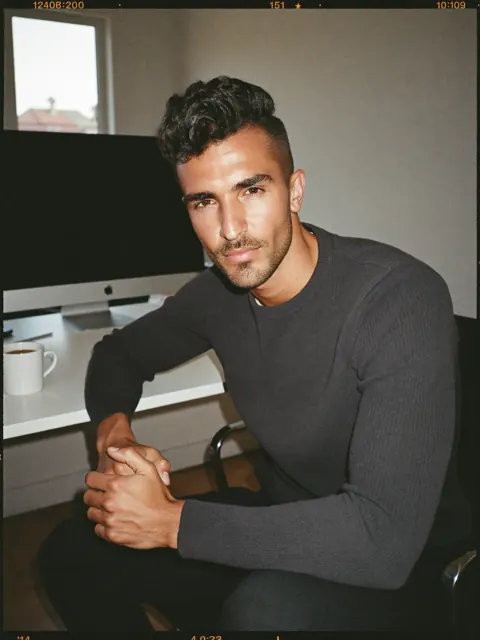 AJ, at a desk